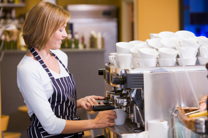 Barista preparing coffee behind the counter