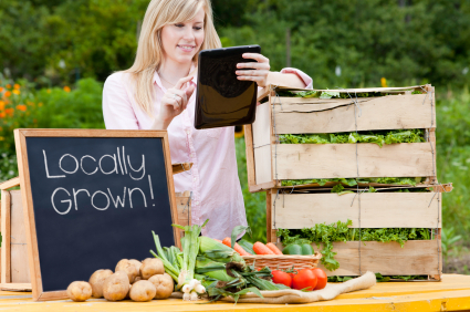 Local produce merchant taking an order on a tablet