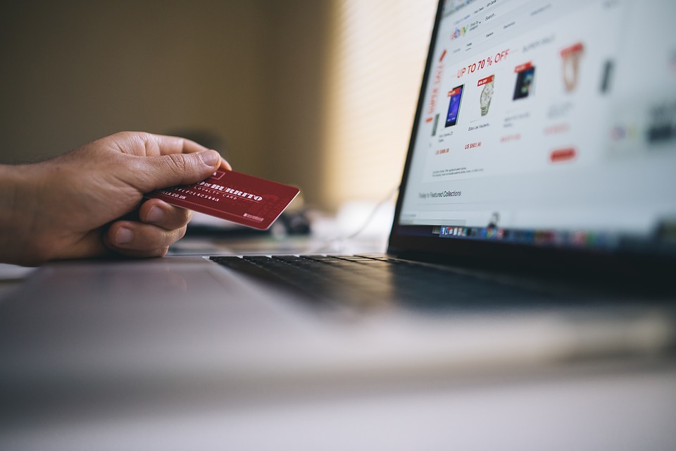 Customer paying online with a card at a laptop