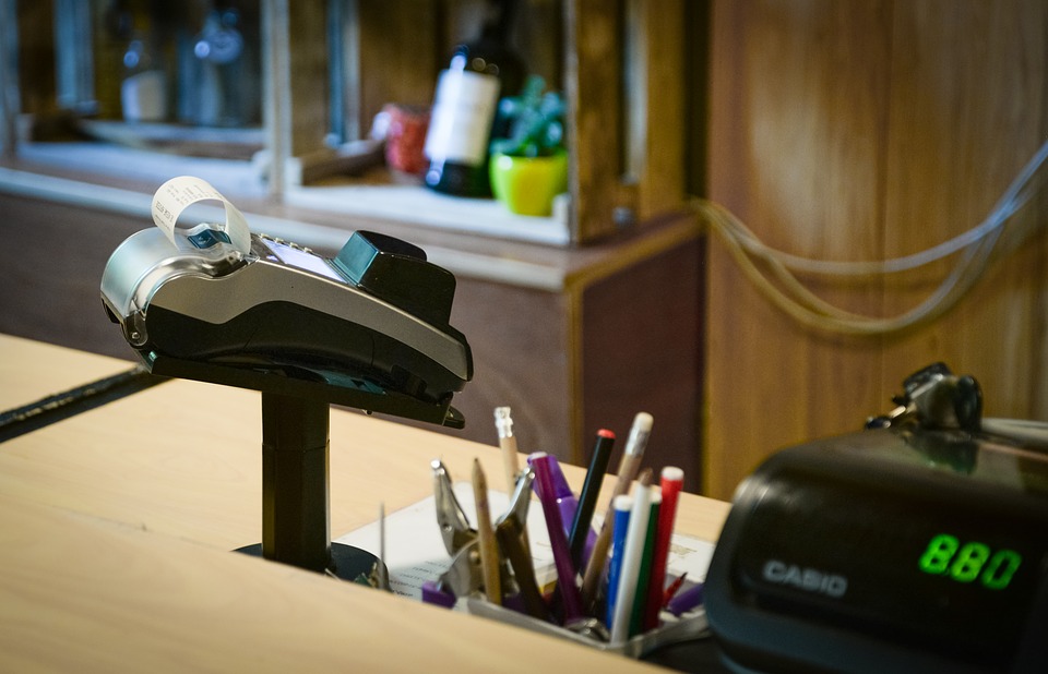 Payment terminal printing a receipt at a shop counter